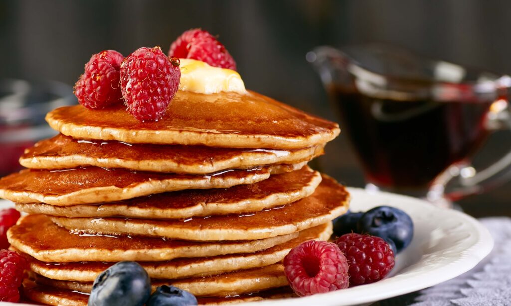 gluten free pacakes for breafkast with berries. Pancakes with berries and maple syrup. Breakfast concept