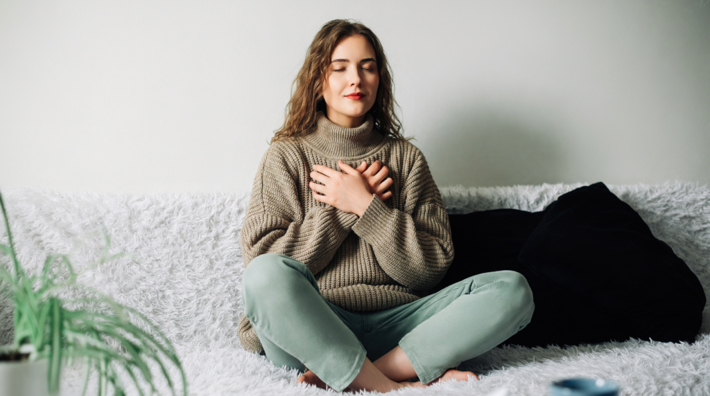 woman meditating in her bed cozy atmosphere