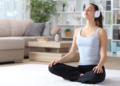 young woman meditating while listening to relaxing music